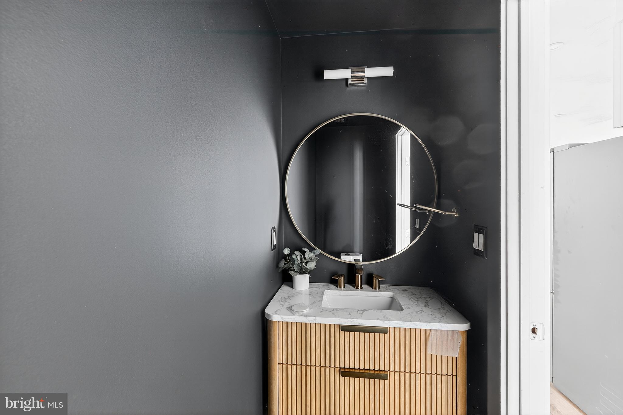 828 21st Street Northeast, Unit 1 Washington, DC 20002 - Photo 16 of 30 a bathroom with a granite countertop and a mirror