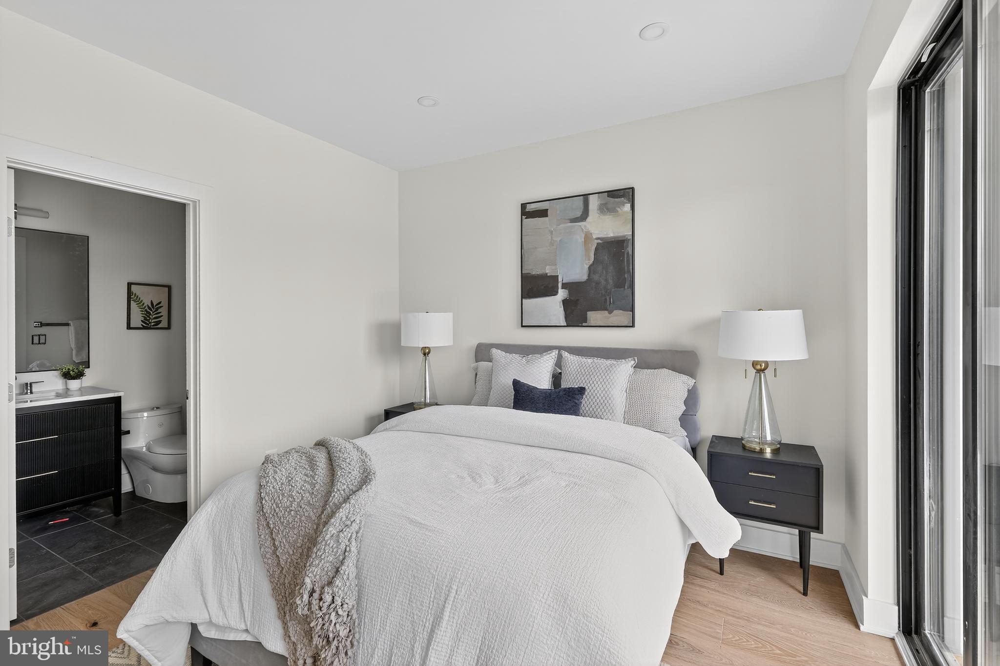 828 21st Street Northeast, Unit 1 Washington, DC 20002 - Photo 19 of 30 a bedroom with a bed and a table