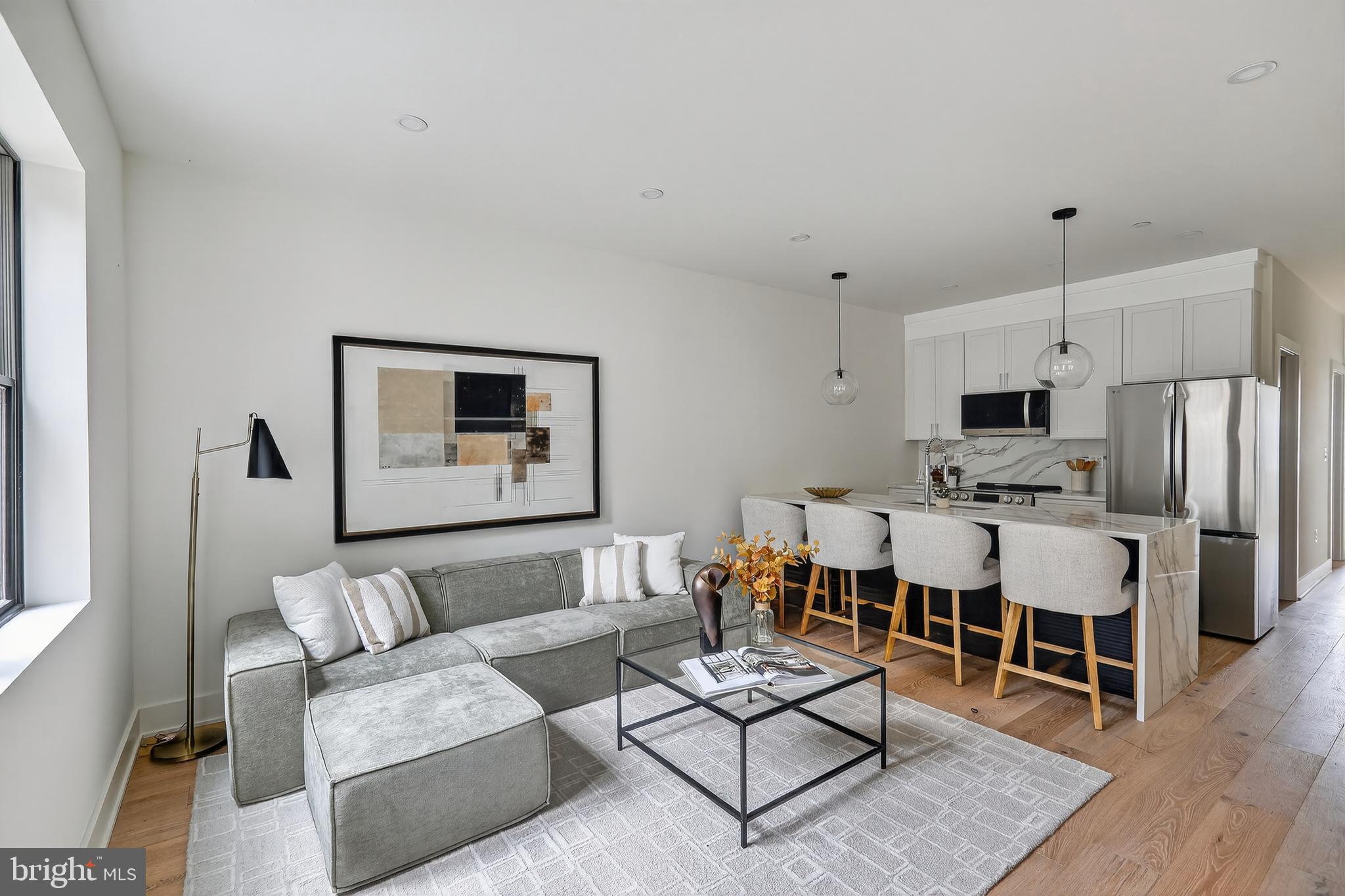 828 21st Street Northeast, Unit 1 Washington, DC 20002 - Photo 3 of 30 a living room with furniture a wooden floor and kitchen view