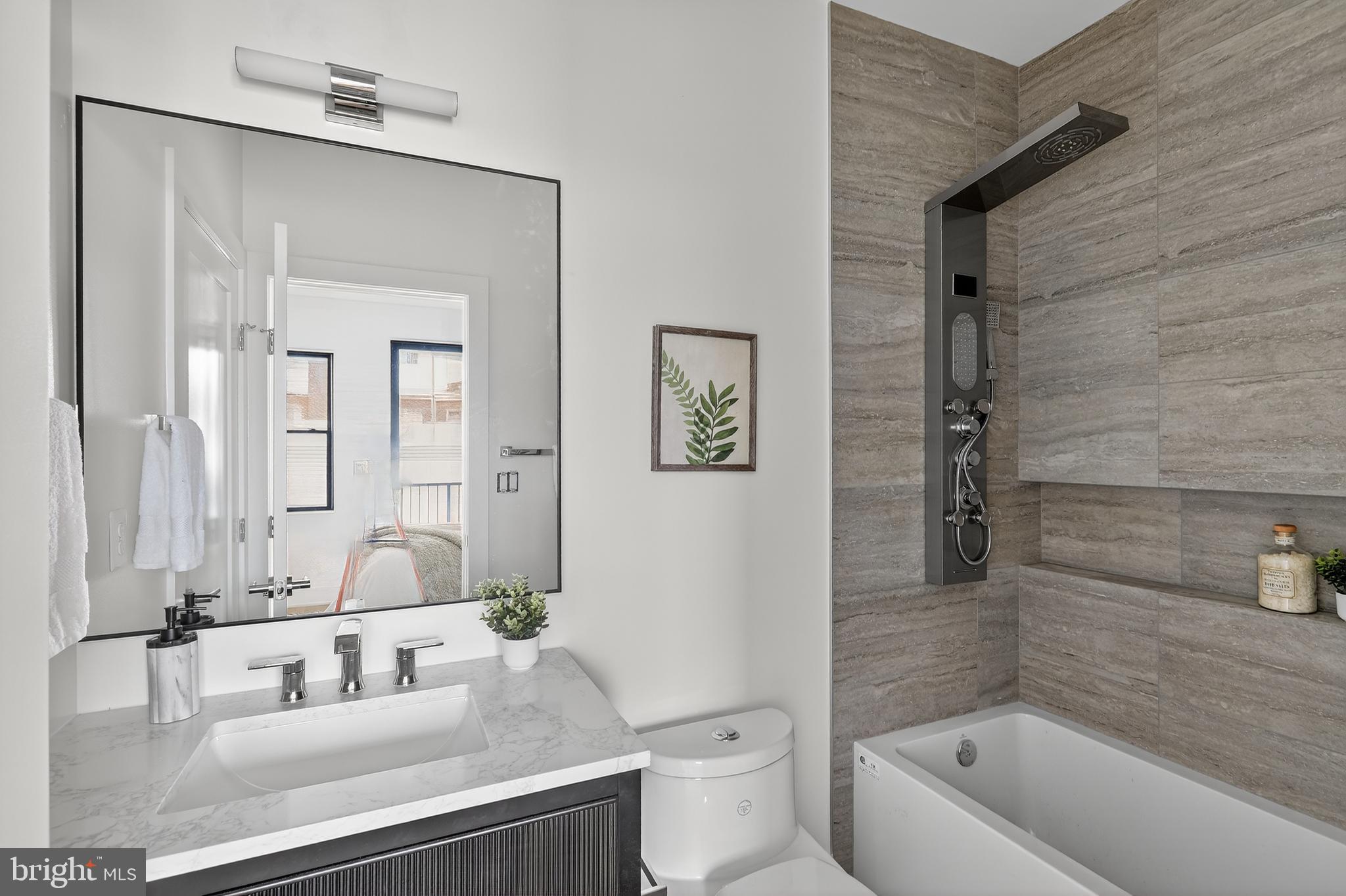 828 21st Street Northeast, Unit 1 Washington, DC 20002 - Photo 4 of 30 a bathroom with a sink a toilet and shower