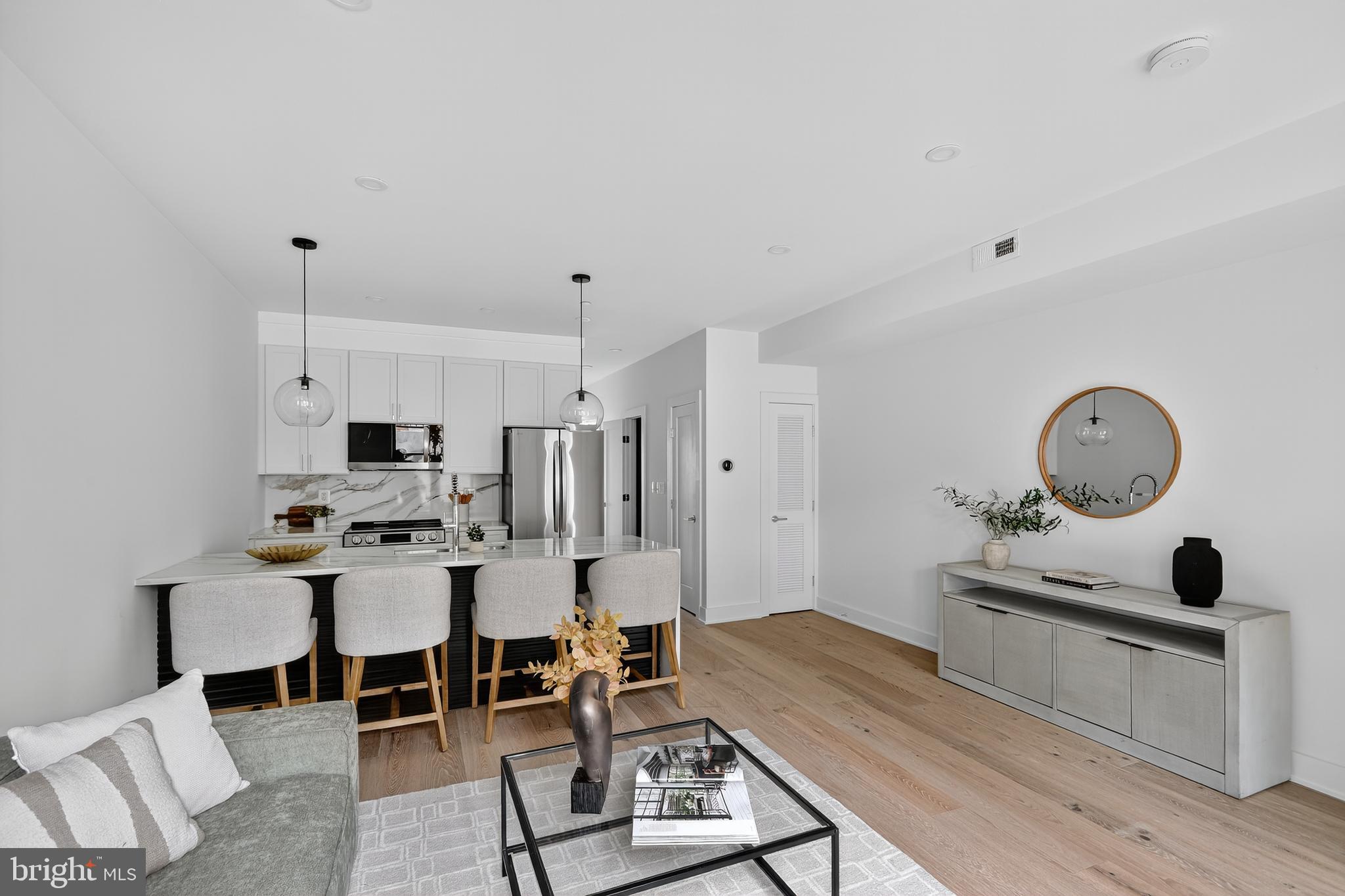 828 21st Street Northeast, Unit 1 Washington, DC 20002 - Photo 10 of 30 a living room with furniture a clock and a table