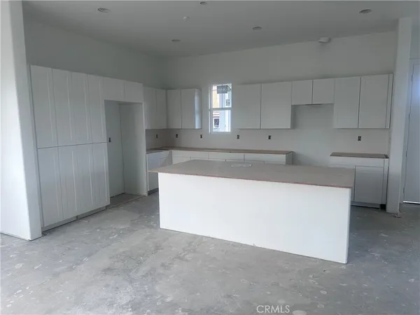 a utility room with cabinets washer and dryer