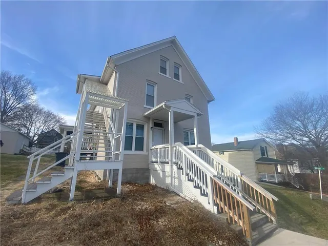 a front view of a house with stairs