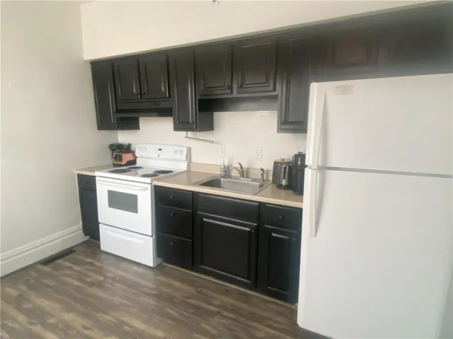 a kitchen with a sink cabinets and appliances