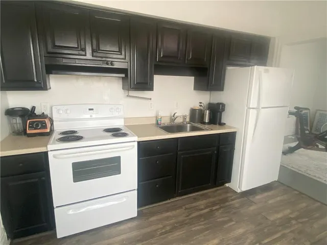 a kitchen with a sink a stove and refrigerator