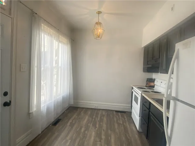 a kitchen with a sink a refrigerator and window