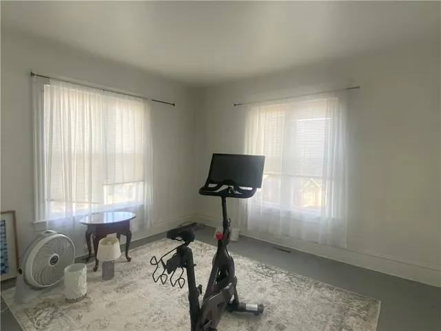 a room with gym equipment and a window