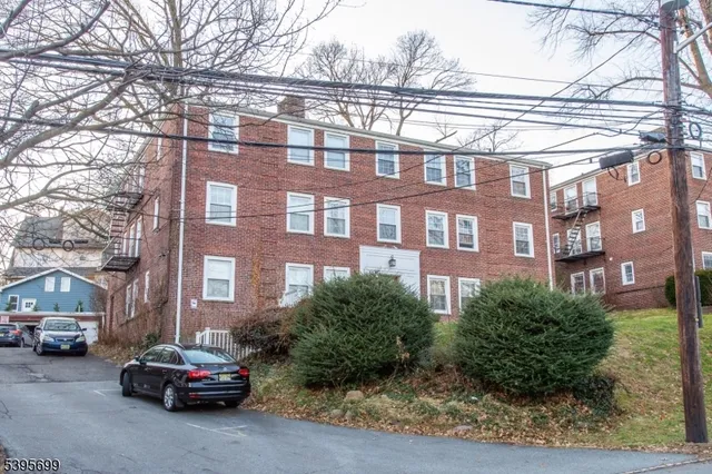 a front view of a brick house with a yard