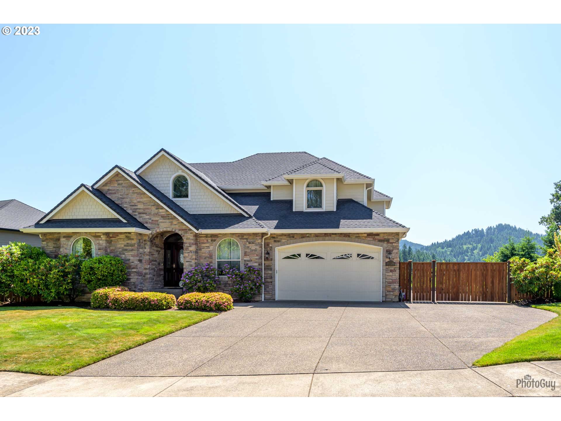 6099 Graystone Loop Springfield, OR 97478 - Photo 2 of 48 a view of a white house with a small yard and wooden fence