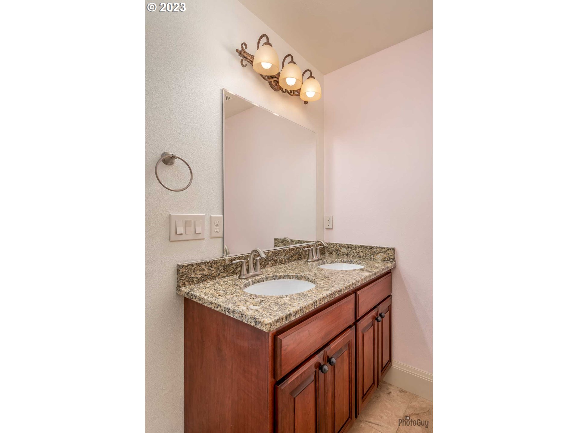 6099 Graystone Loop Springfield, OR 97478 - Photo 37 of 48 a bathroom with a granite countertop sink and a mirror