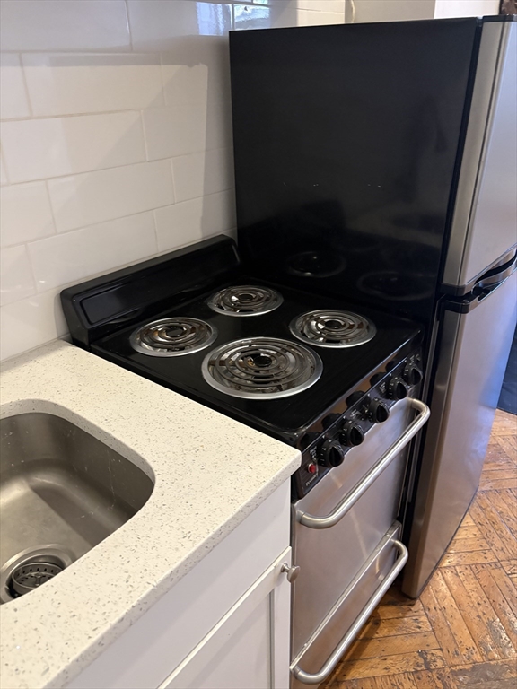 211 Beacon Street, Unit 2R Boston, MA 02116 - Photo 4 of 6 a stove top oven sitting inside of a kitchen