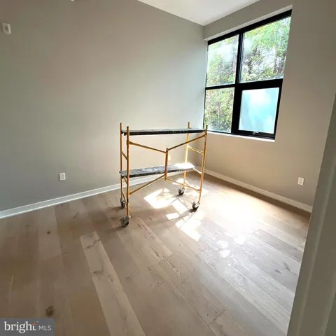 an empty room with windows and entrance