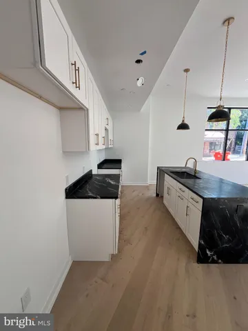 a kitchen with stainless steel appliances a sink a stove and a refrigerator