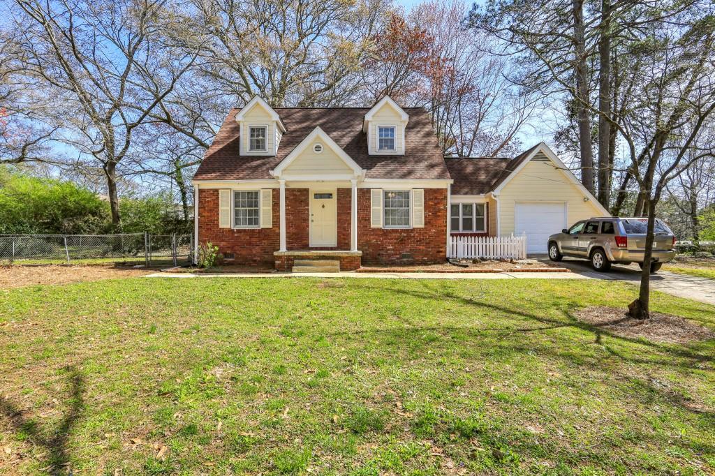 1659 Spruce Valley Drive Decatur, GA 30033 - Photo 1 of 1 a front view of a house with a yard table and chairs