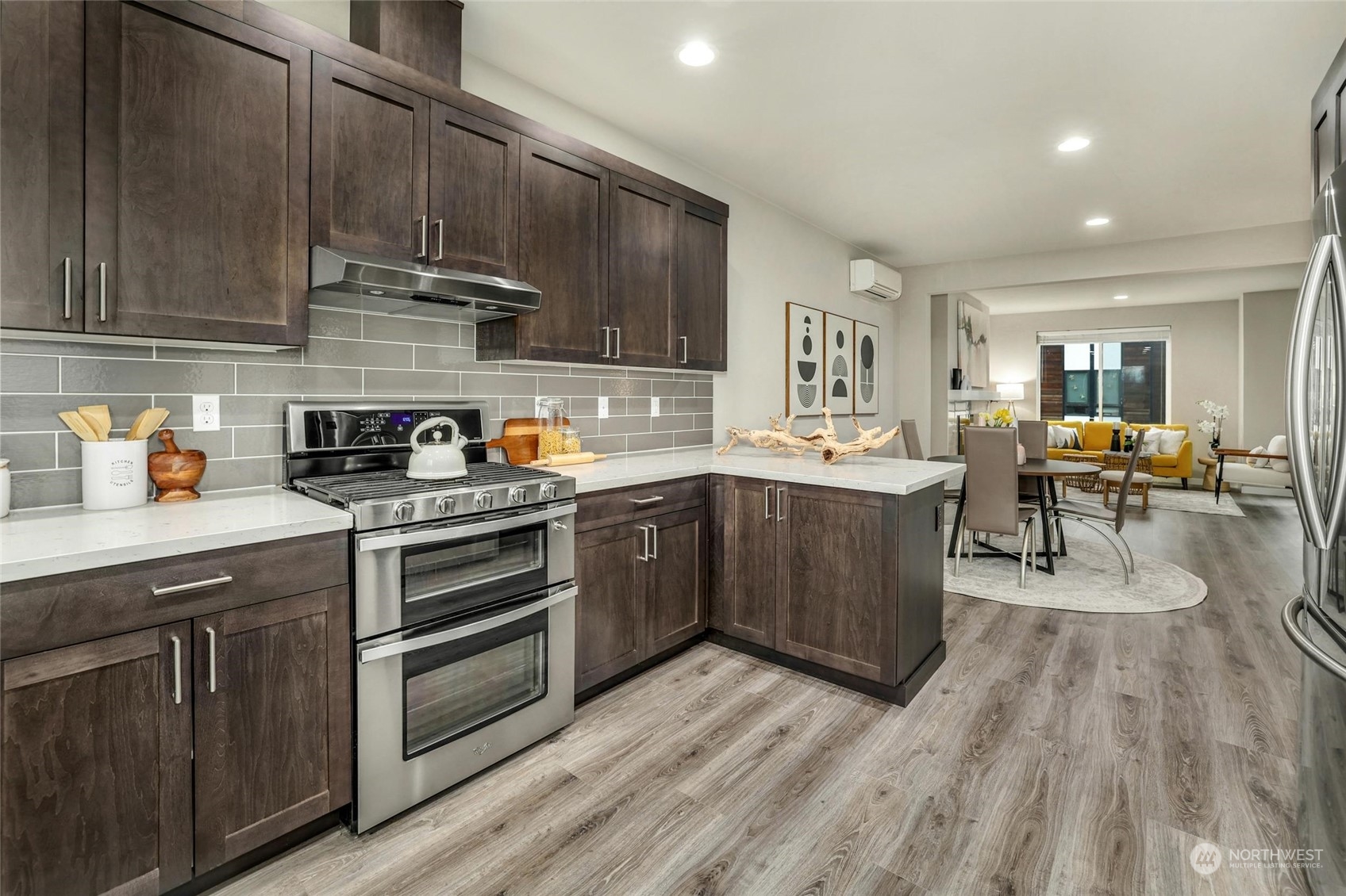 12718 35th Avenue Southeast, Unit E2 Everett, WA 98208 - Photo 12 of 28 a kitchen with stainless steel appliances granite countertop wooden cabinets a sink dishwasher a stove and a refrigerator with wooden floor