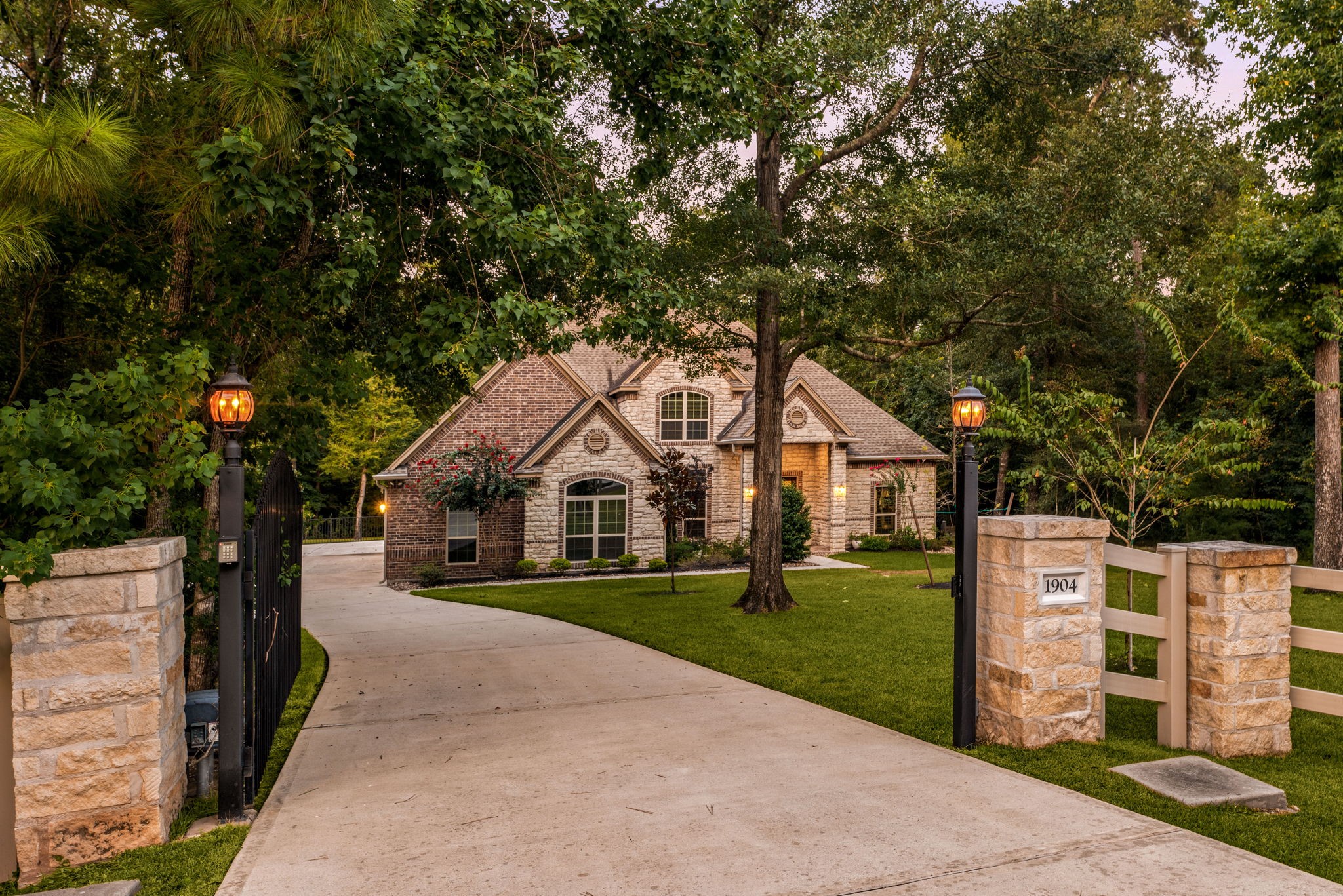 1904 Boulder Ridge Drive Conroe, TX 77304 - Photo 9 of 37 Serene luxury awaits in Conroe's highly sought-after Dominion Ridge neighborhood! This magnificent home is tucked away on a sprawling, 2 acre tree-lined lot, offering unparalleled curb appeal and a peaceful retreat from the everyday hustle.