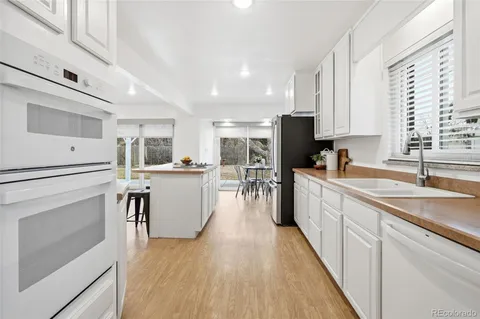 a kitchen with counter top space a sink cabinets and stainless steel appliances