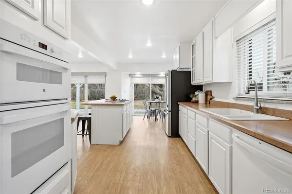 a kitchen with counter top space a sink cabinets and stainless steel appliances