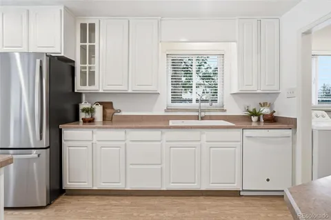 a kitchen with stainless steel appliances granite countertop a refrigerator sink and cabinets