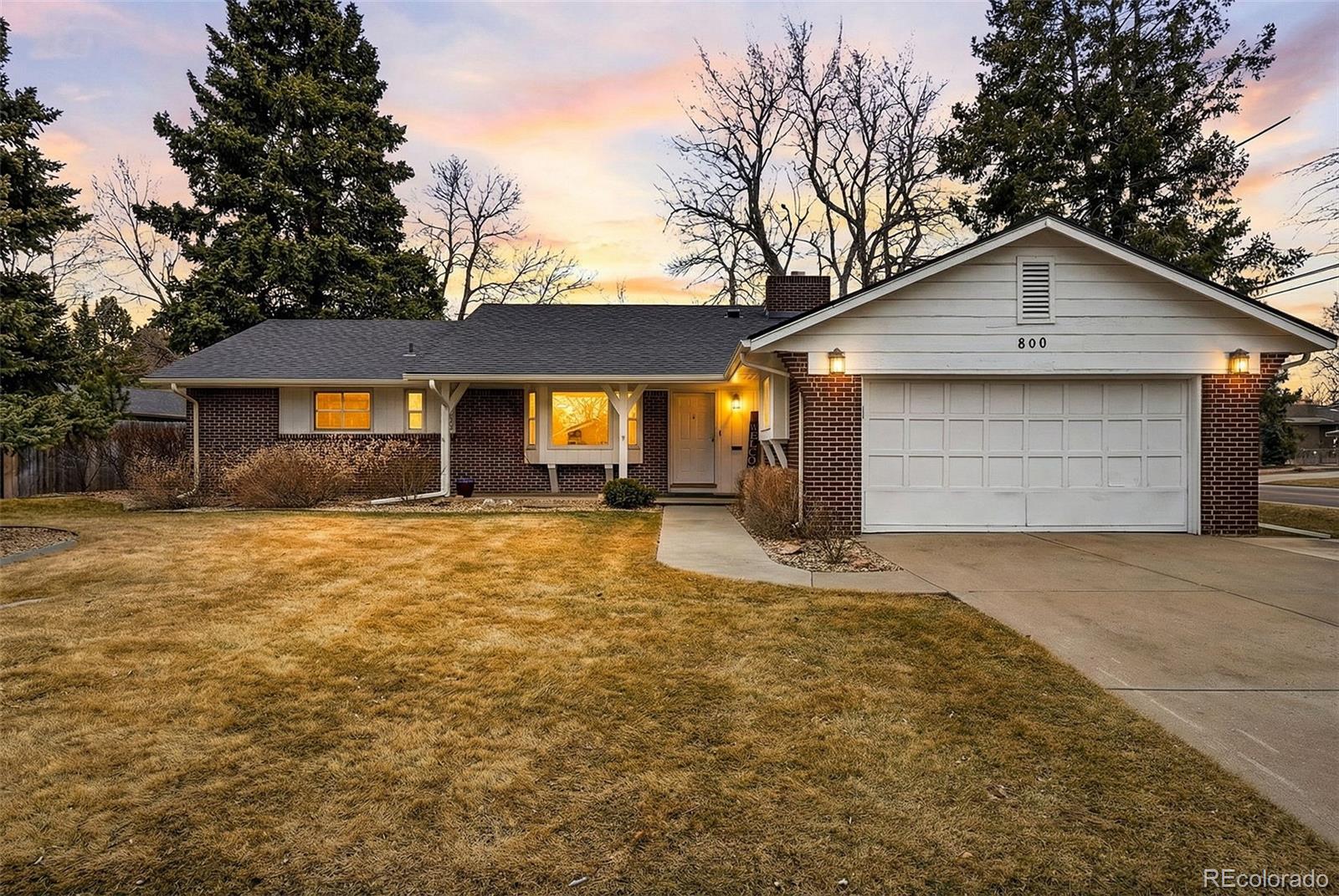 800 East Pinewood Avenue Littleton, CO 80121 - Photo 2 of 42 a front view of a house with a yard and garage