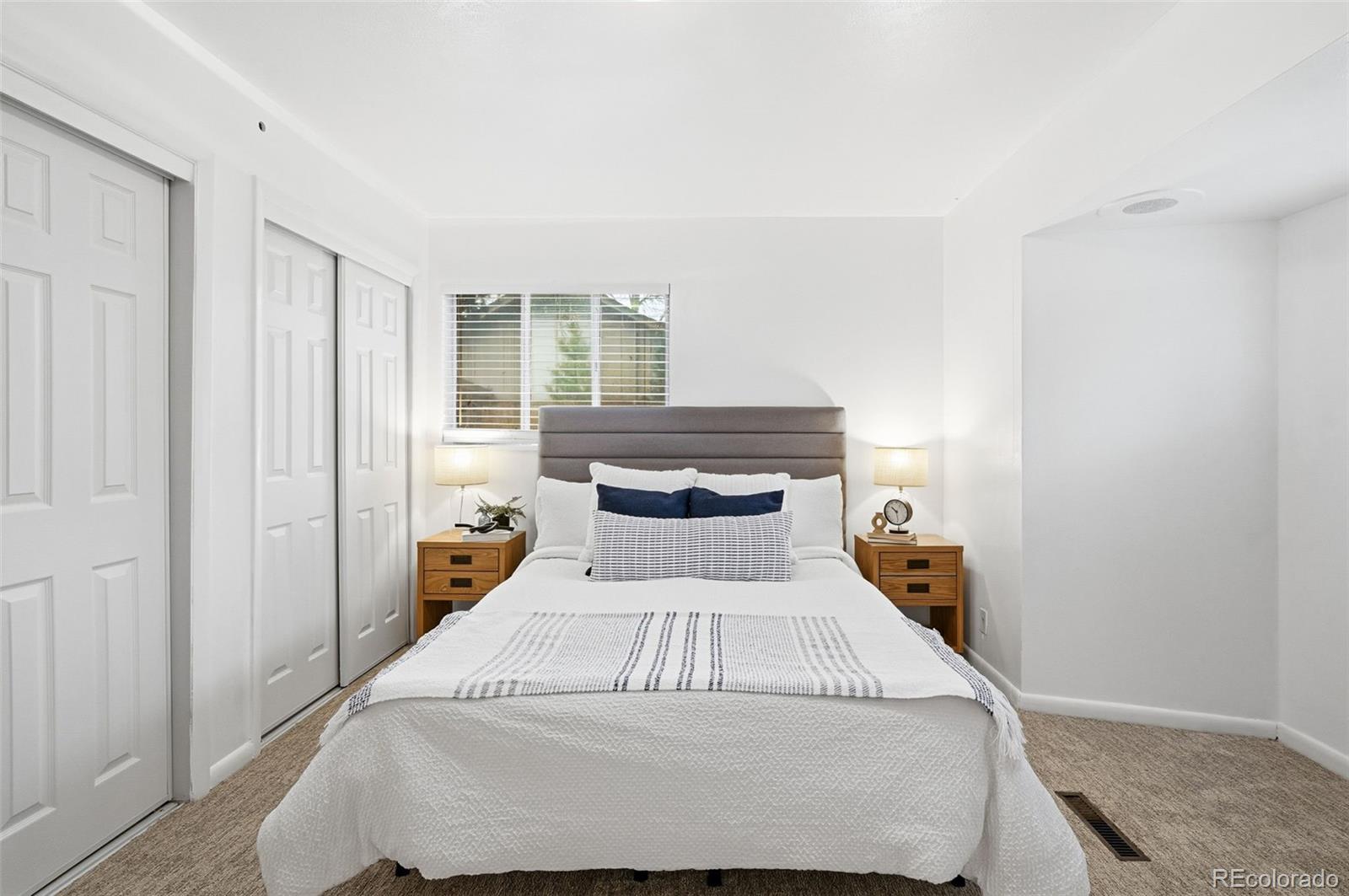 800 East Pinewood Avenue Littleton, CO 80121 - Photo 21 of 42 a bedroom with a bed and wooden floor