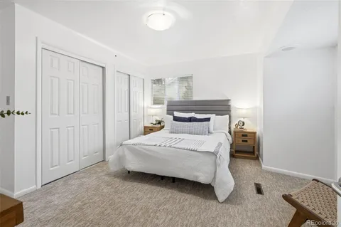 a bedroom with a bed and a desk