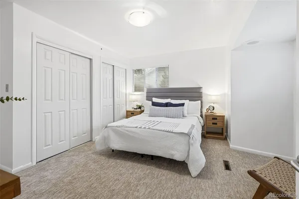 a bedroom with a bed and a desk