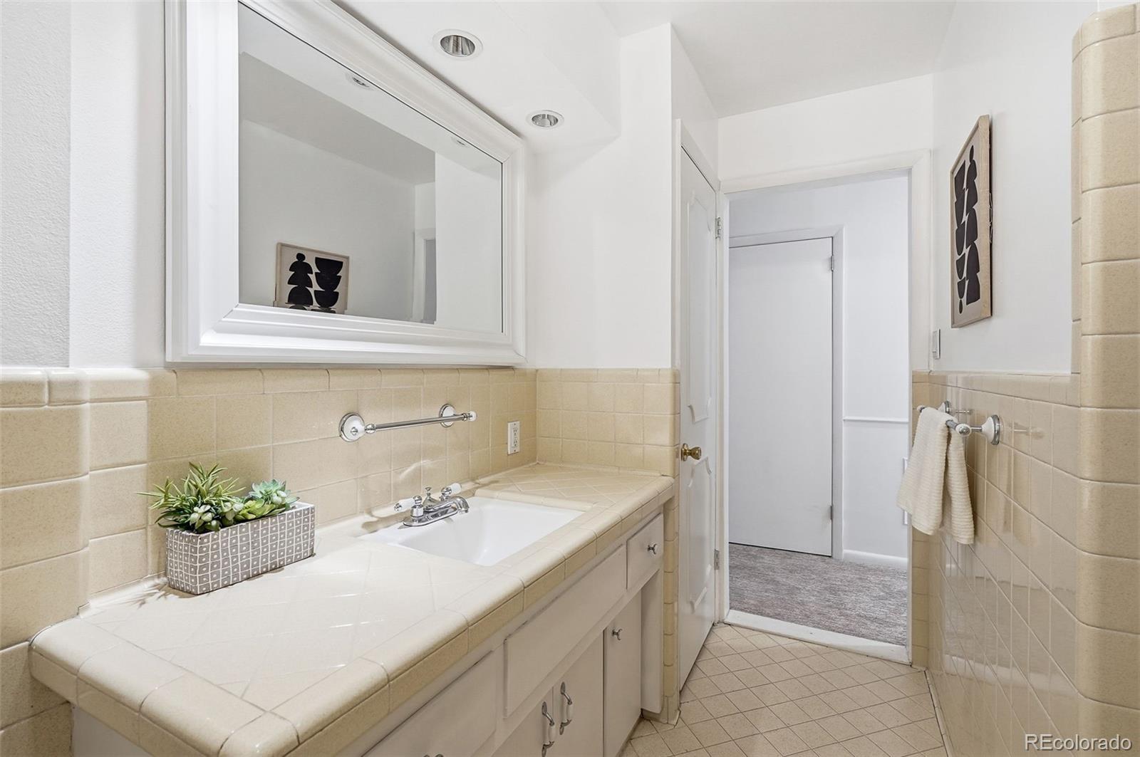 800 East Pinewood Avenue Littleton, CO 80121 - Photo 30 of 42 a bathroom with a sink and a mirror