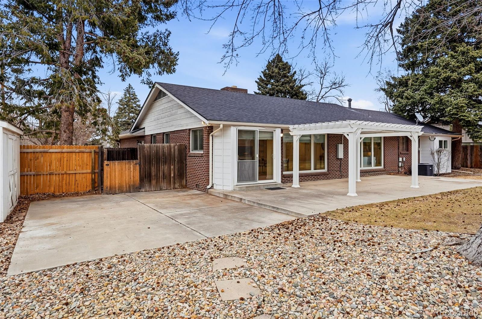 800 East Pinewood Avenue Littleton, CO 80121 - Photo 39 of 42 a front view of a house with a garden