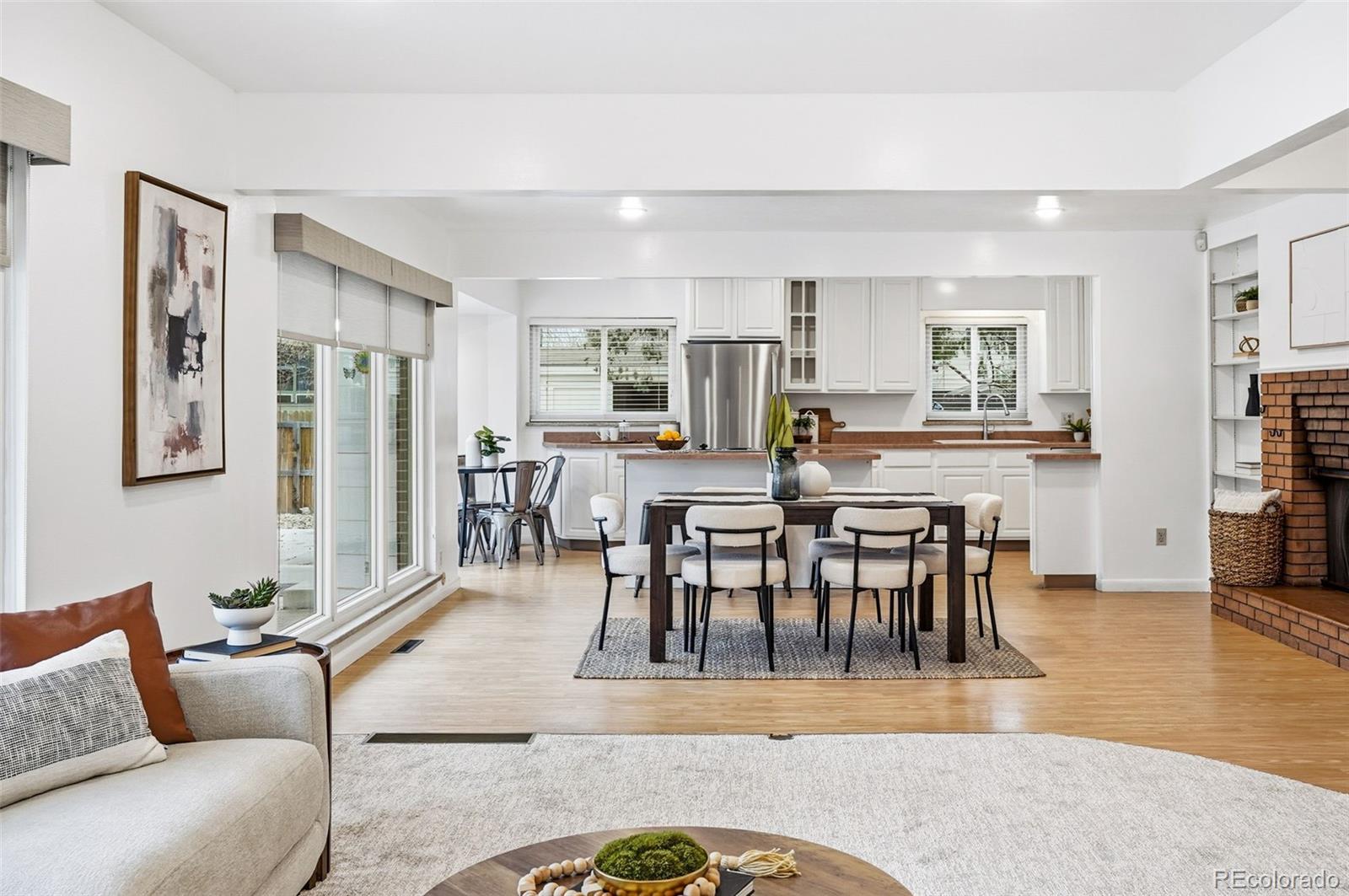 800 East Pinewood Avenue Littleton, CO 80121 - Photo 7 of 42 a view of a dining room with furniture and wooden floor