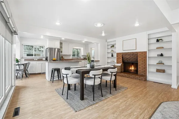 a dining room with furniture and wooden floor