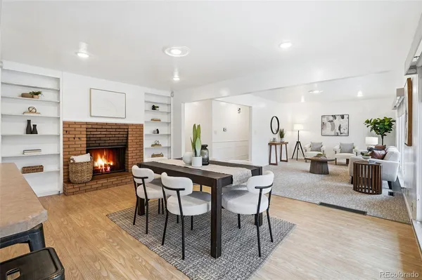 a dining room with furniture and wooden floor