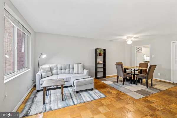 a living room with furniture a dining table and a piano table