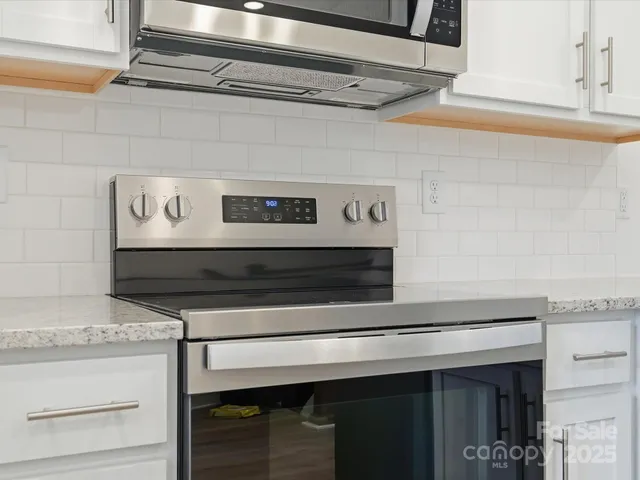 a stove top oven sitting inside of a kitchen