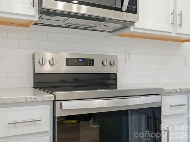a stove top oven sitting inside of a kitchen
