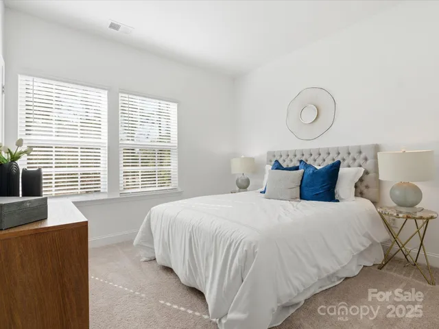 a bedroom with bed and wooden floor