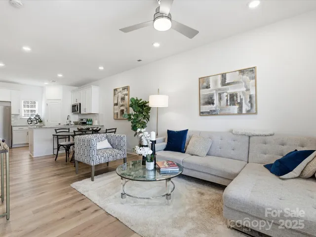 a living room with furniture and view of kitchen
