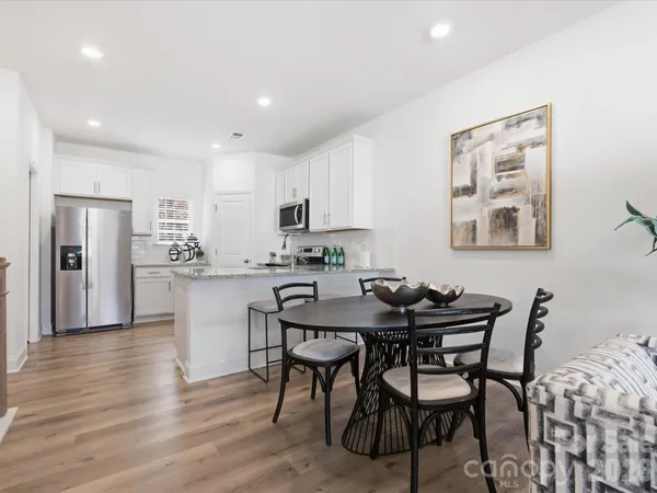 a view of a dining room with furniture and wooden floor