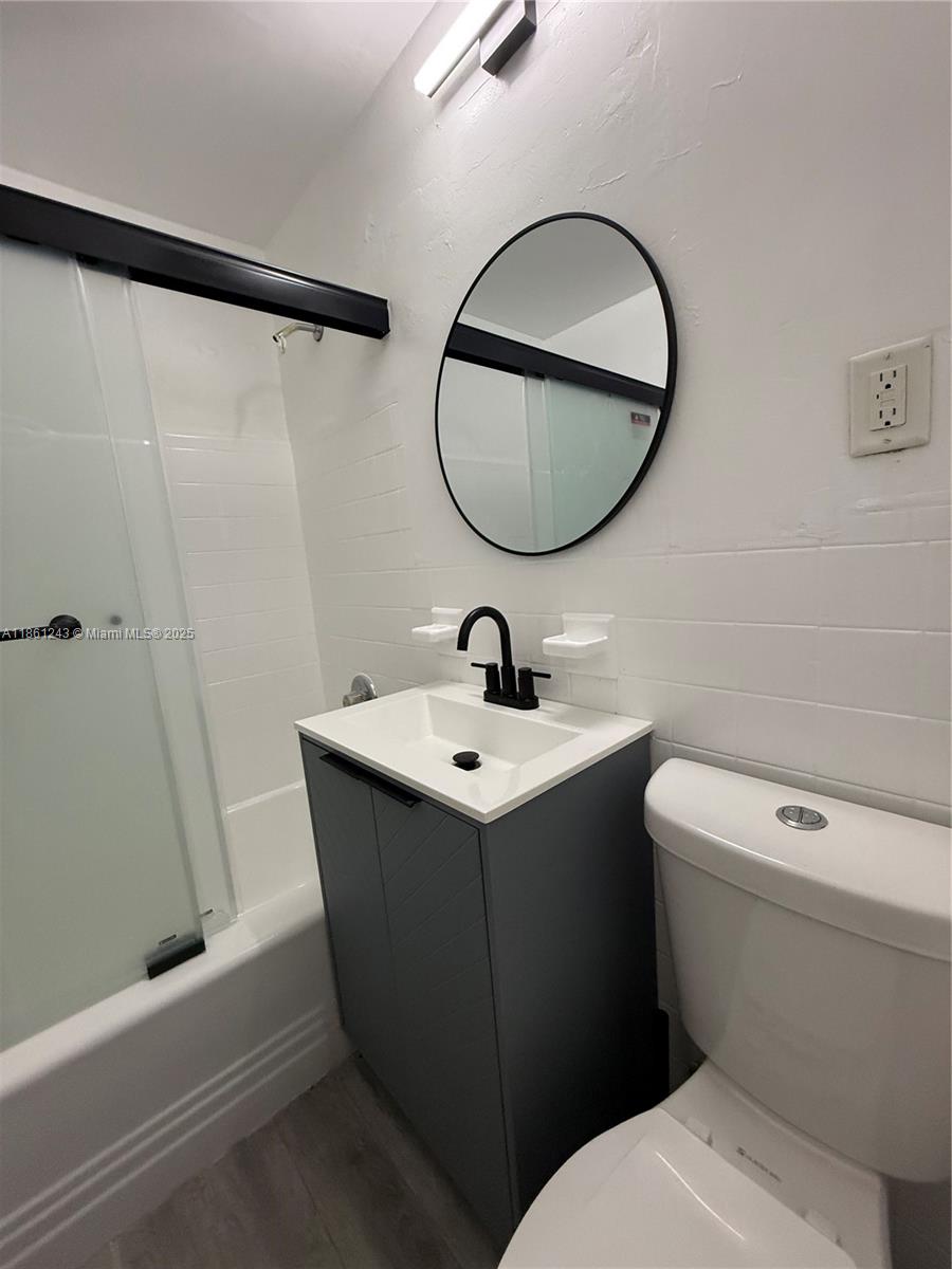 233 80th Street, Unit 1 Miami Beach, FL 33141 - Photo 17 of 24 a bathroom with a sink toilet and shower