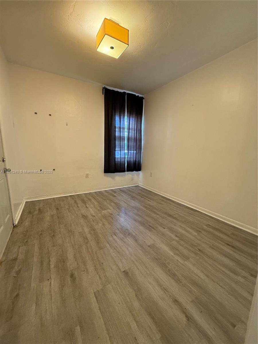 233 80th Street, Unit 1 Miami Beach, FL 33141 - Photo 9 of 24 an empty room with a window