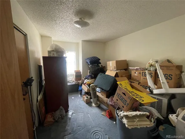 a kitchen with refrigerator and chairs