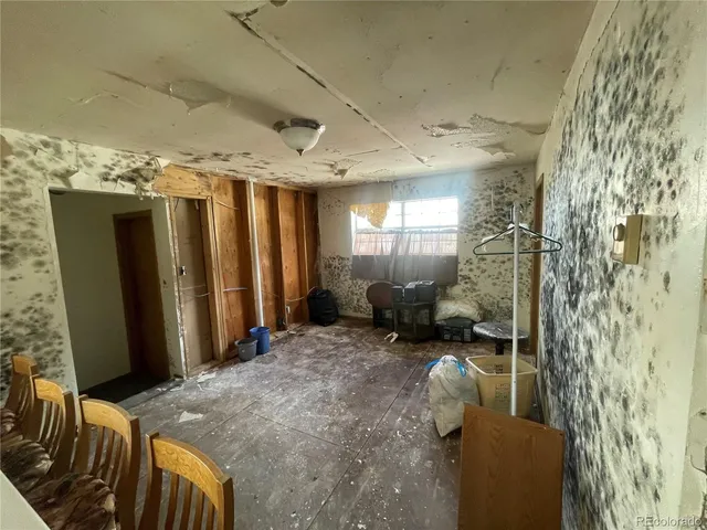 a view of a livingroom with furniture and staircase