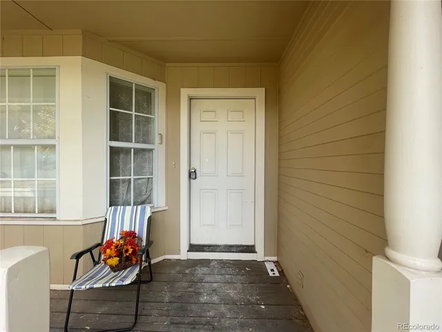 a living room filled with furniture and a potted plant