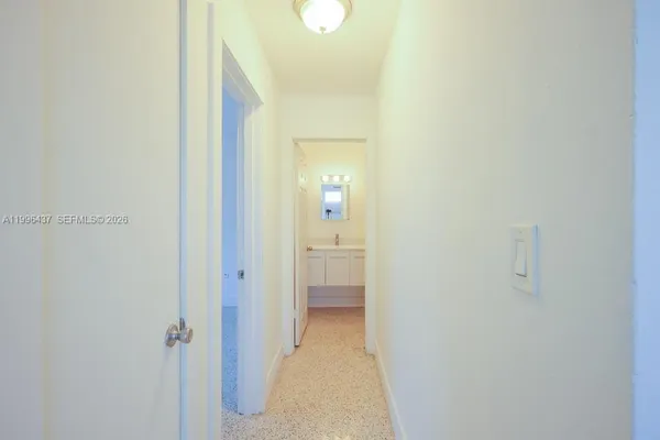 a view of a bathroom from a hallway