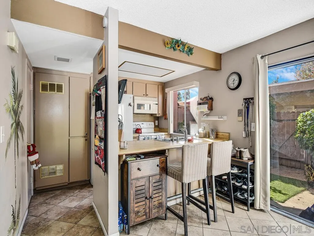 8022 Winter Gardens Boulevard, Unit E El Cajon, CA 92021 - Photo 12 of 30 a kitchen with stainless steel appliances granite countertop a refrigerator and microwave