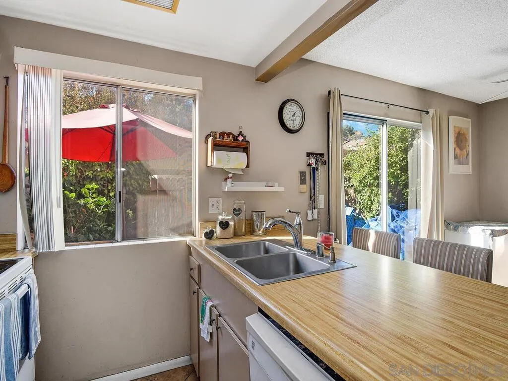 8022 Winter Gardens Boulevard, Unit E El Cajon, CA 92021 - Photo 13 of 30 a kitchen with a wooden floor a sink and a large window