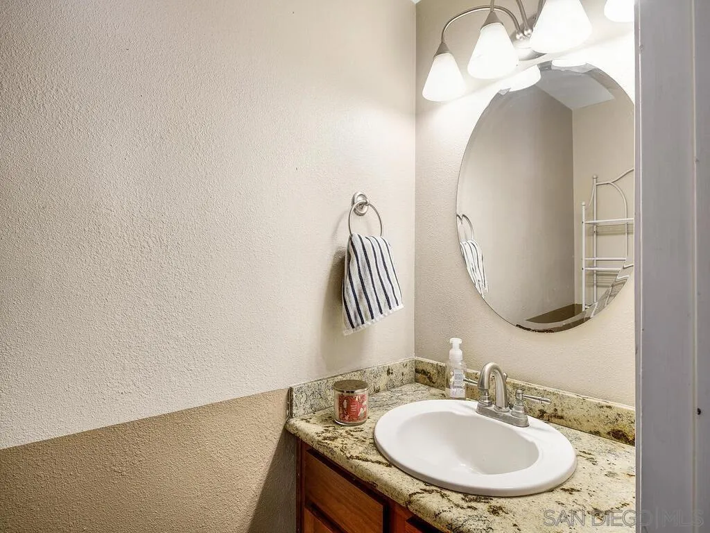 8022 Winter Gardens Boulevard, Unit E El Cajon, CA 92021 - Photo 16 of 30 a bathroom with a sink and a mirror