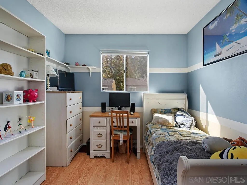 8022 Winter Gardens Boulevard, Unit E El Cajon, CA 92021 - Photo 17 of 30 a bedroom with a bed and a window
