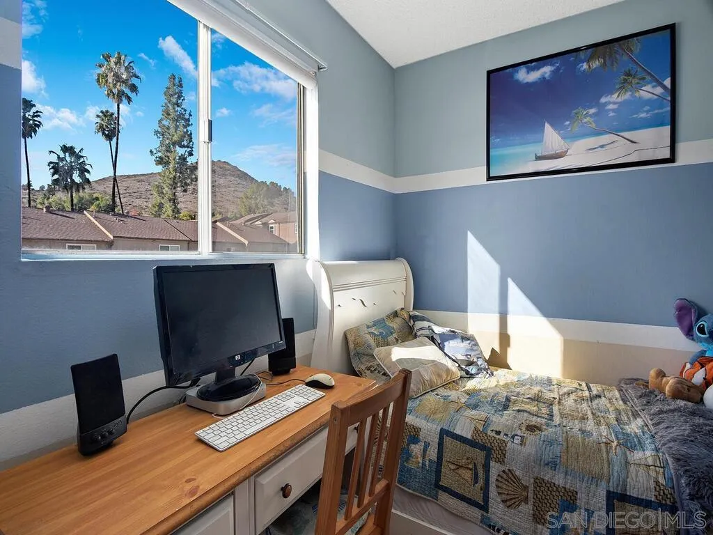 8022 Winter Gardens Boulevard, Unit E El Cajon, CA 92021 - Photo 18 of 30 a bedroom with a bed and a desk