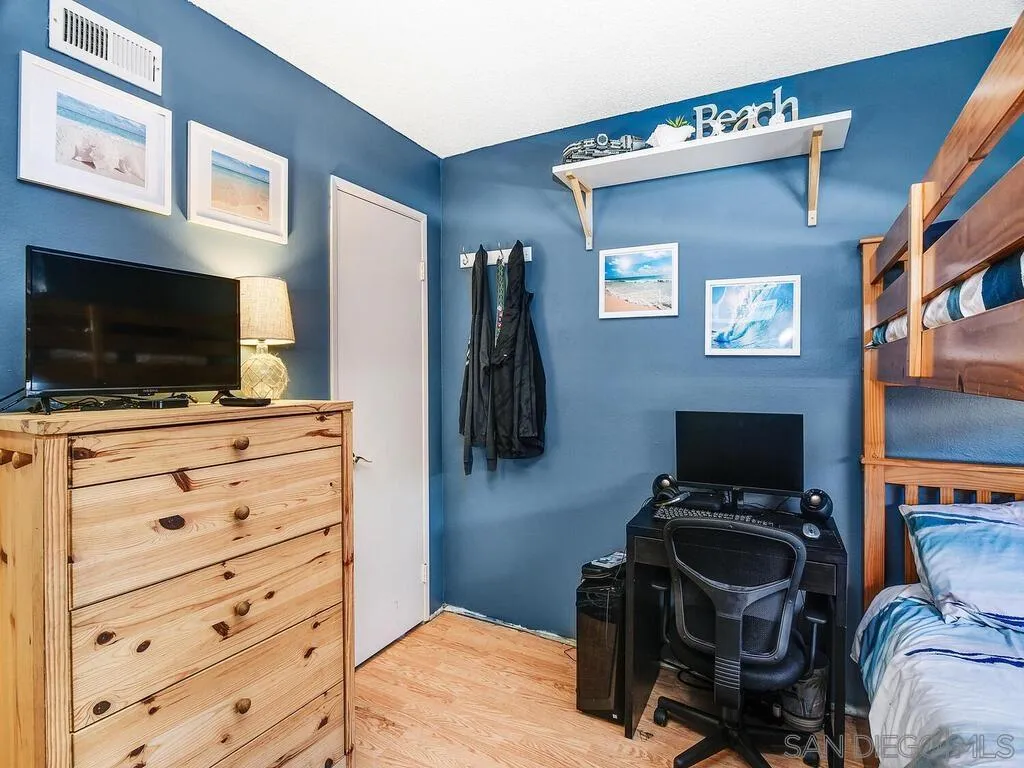8022 Winter Gardens Boulevard, Unit E El Cajon, CA 92021 - Photo 20 of 30 a room with furniture and flat screen tv